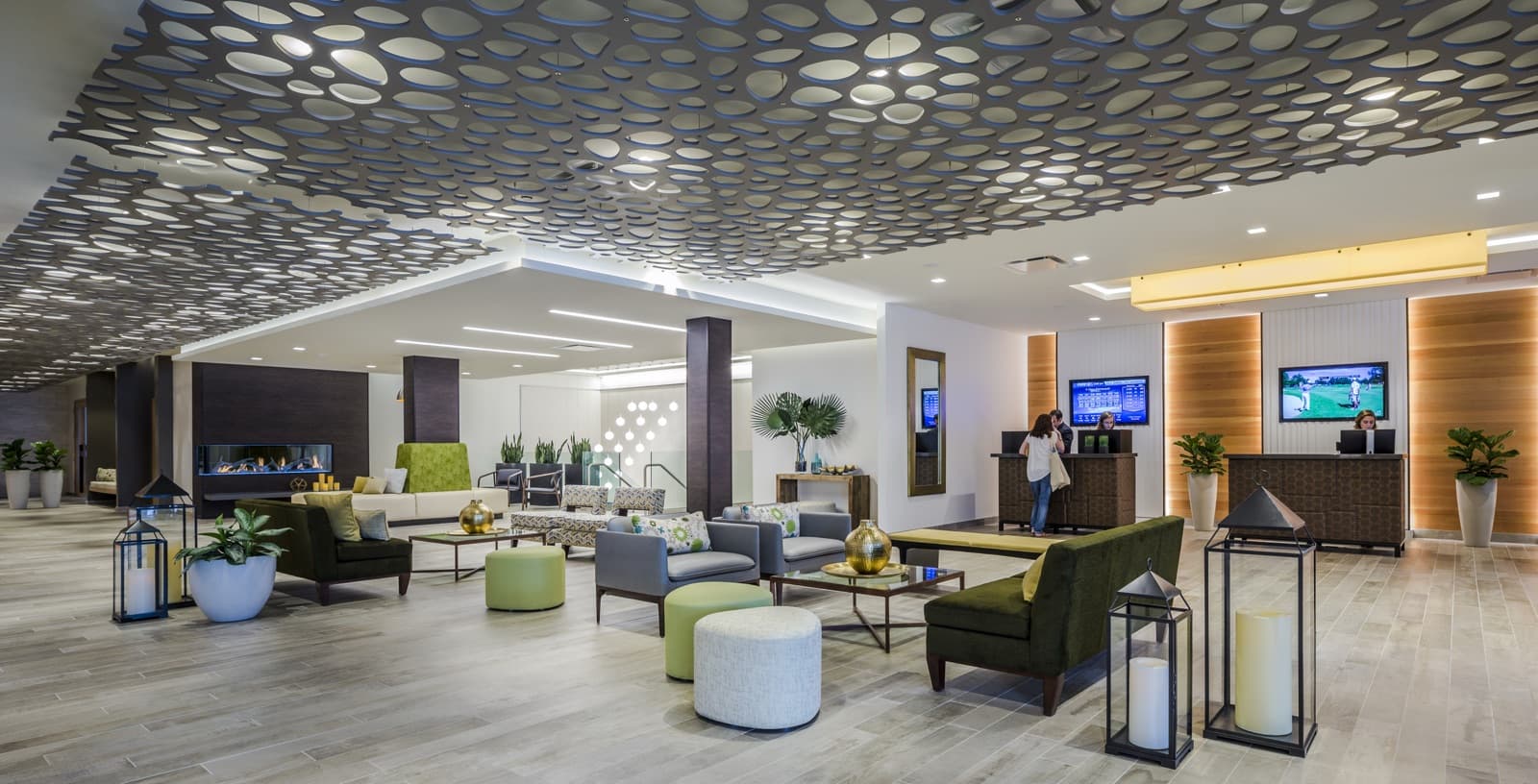 The lobby of Lodge Geneva National, with sofas and lanterns under a patterned ceiling